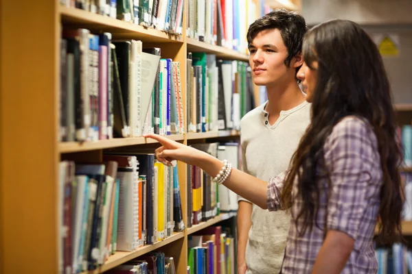 Students choosing a book — Zdjęcie stockowe