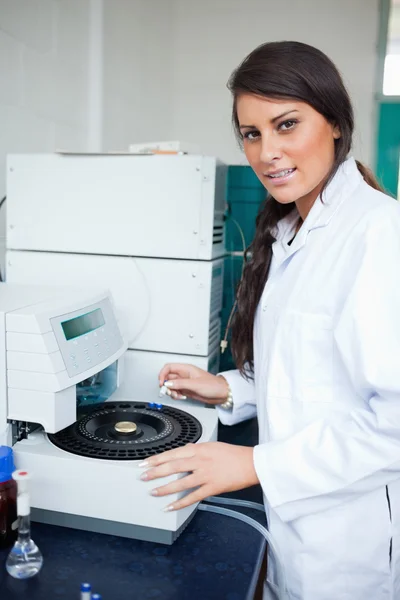 Serious scientist using a centrifuge — Stock Photo, Image