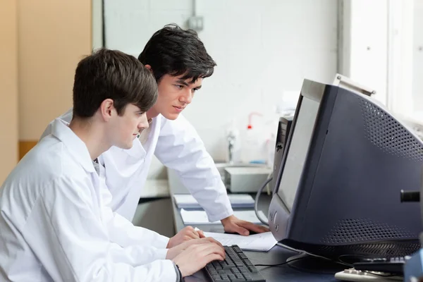 Scientists working with a monitor — Stock Photo, Image