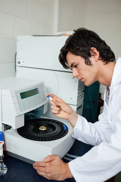 Portrait of a a student using a centrifuge — Stock Photo, Image