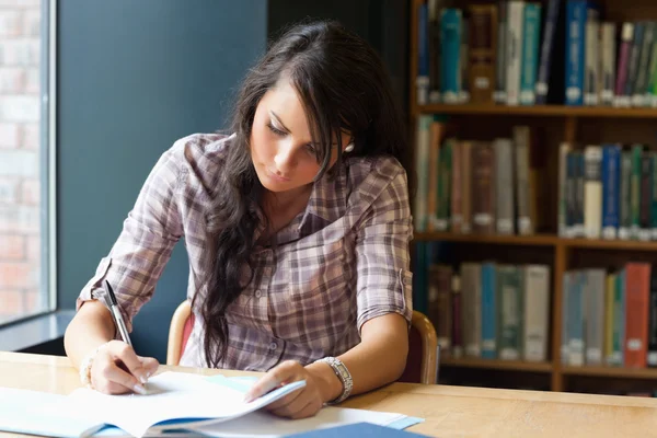 Young student writing — Stock Photo, Image