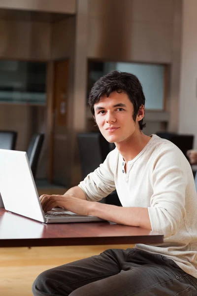 Portrait of a handsome man using a laptop — Stock Photo, Image