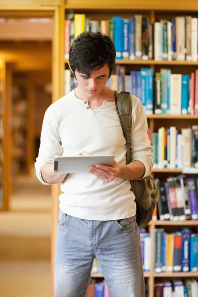 Портрет сфокусированного студента с помощью планшетного компьютера — стоковое фото