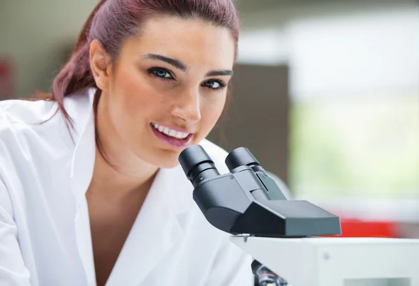 Close up de um cientista posando com um microscópio — Fotografia de Stock