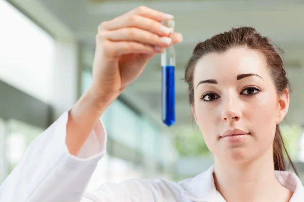 Cute student holding a test tube — Stock Photo, Image
