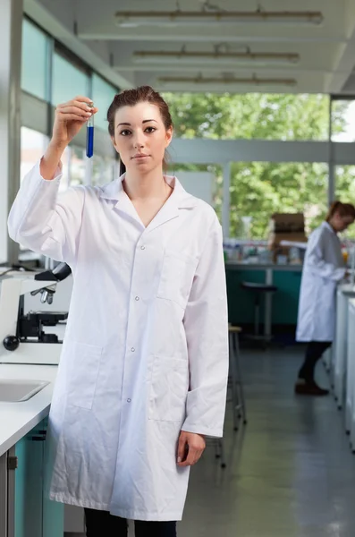 Portrait of a beautiful scientist holding a test tube — Stock Photo, Image