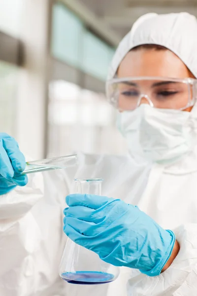 Portrait of a protected scientist pouring liquid — Stock Photo, Image