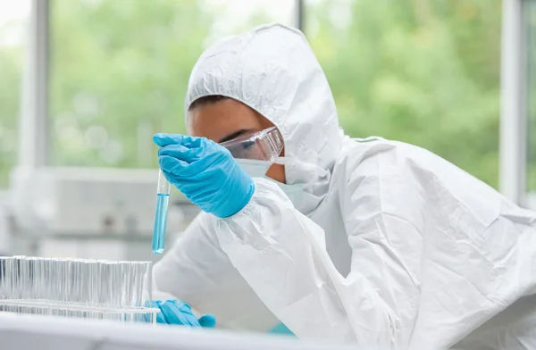 Protected scientist holding a test tube — Stock Photo, Image