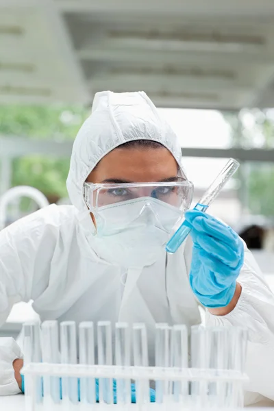 Portrait of a protected female scientist holding a test tube — Stock Photo, Image