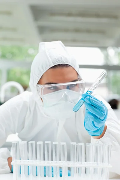 Portrait of a protected science student looking at a test tube — Stock Photo, Image