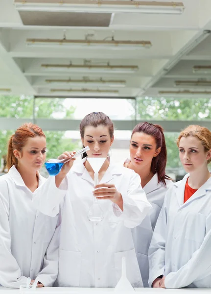 Portrét vědy studentů nalití kapaliny v baňce — Stock fotografie