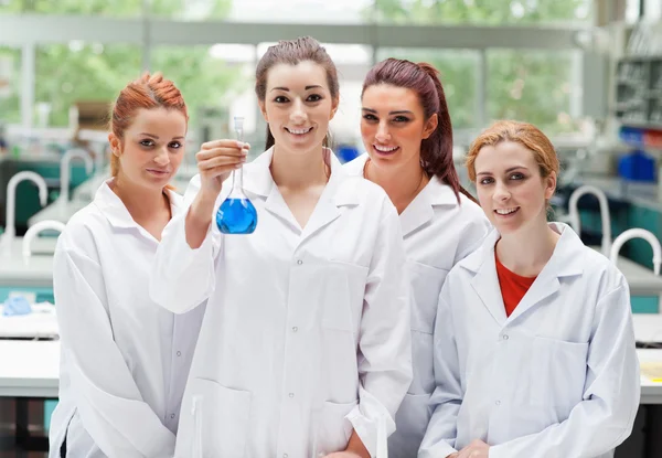 Lab partners posing with a flask — Stock Photo, Image