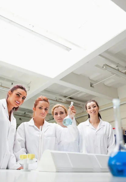 Portrait of chemistry students holding a flask — Stock Photo, Image