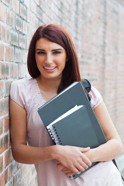Ritratto di una studentessa felice che tiene i suoi raccoglitori — Foto Stock