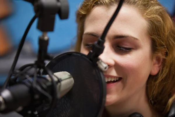 Close up of a young singer recording a track — Stock Photo, Image