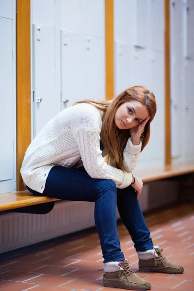 Portrait of a sad student sitting on a bench — Stock Photo, Image