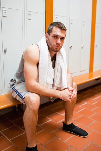 Portrait of a young sports student sitting on a bench — Stock Photo, Image