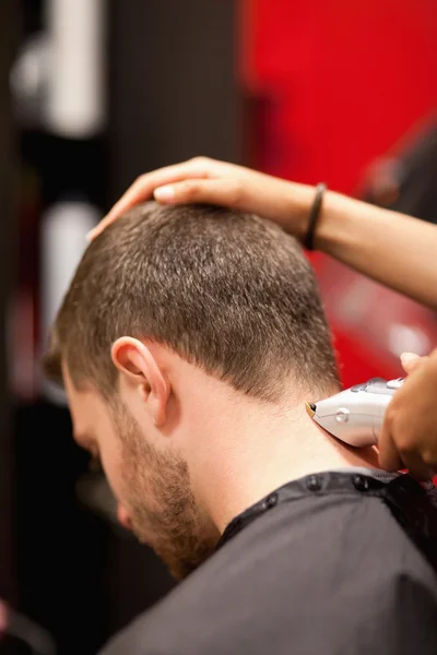 Portrait of a male young student having a haircut — Stock Photo, Image