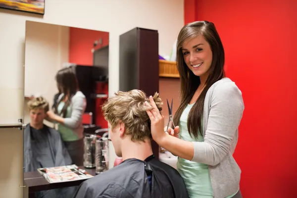 Blond-haired young man having a haircut — Stock Photo, Image