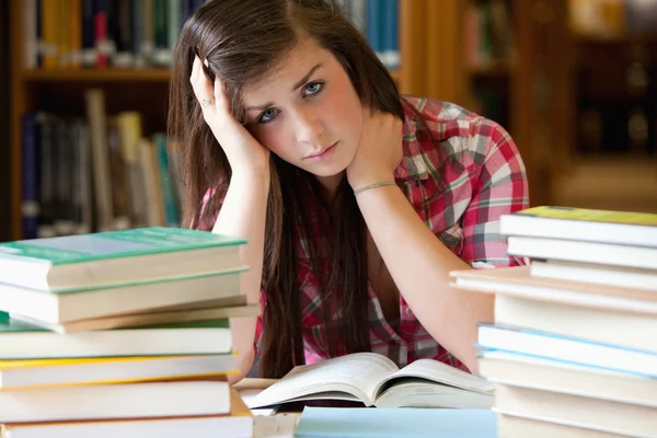 Studente depresso circondato da libri — Foto Stock