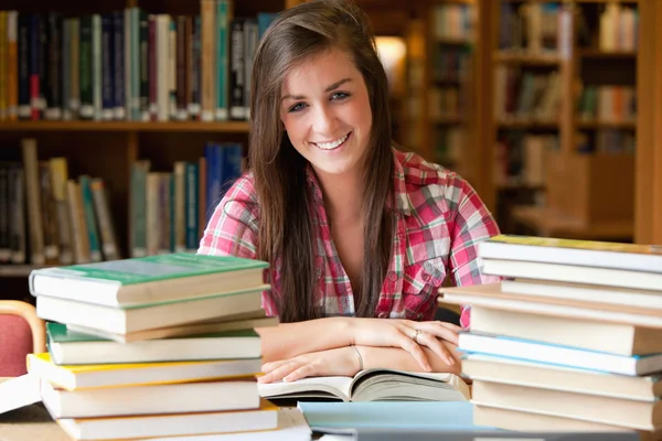Uśmiechający się student o wiele, aby przeczytać — Zdjęcie stockowe