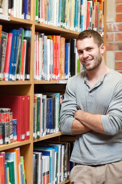 Portret van een glimlachende mannelijke student leunend op een plank — Stockfoto