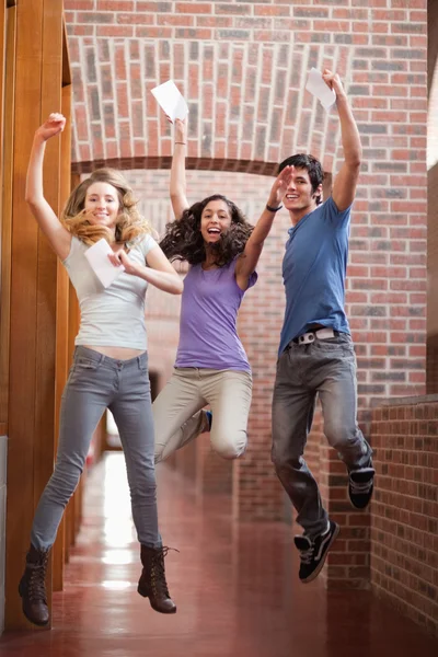 Portrait of successful students jumping — Stock Photo, Image
