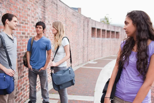 Lonely student looking at her classmates talking — Stock Photo, Image