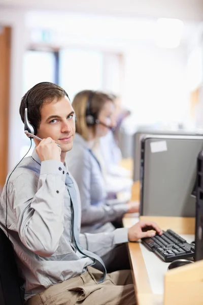 Portrait of a customer assistant using a headset — Stock Photo, Image