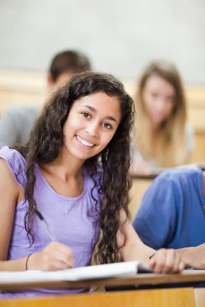 Retrato de um estudante sorrindo tomando notas — Fotografia de Stock