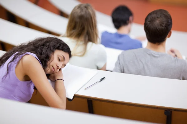 Junge Studentin schläft während einer Vorlesung — Stockfoto