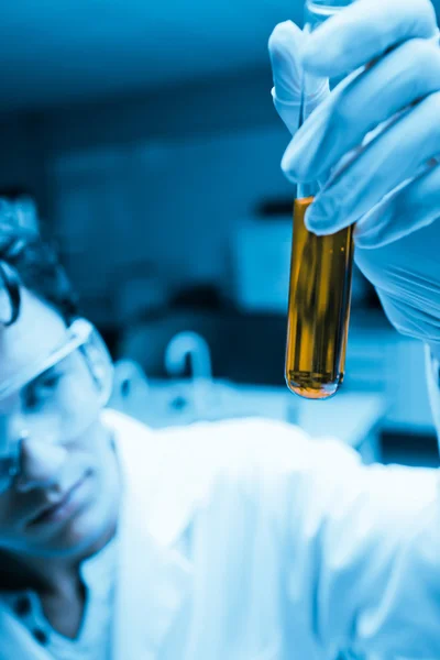Portrait of a male scientist looking at a test tube — Stock Photo, Image