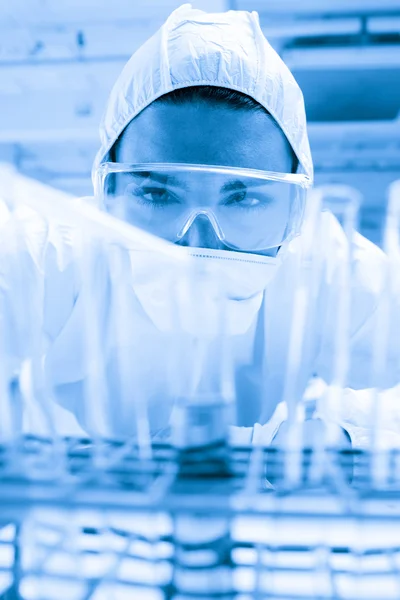 Sıvı bir test tüpü içinde bırakarak korumalı bilim adamı — Stok fotoğraf