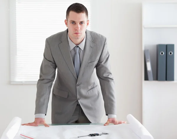 Architect standing behind a table — Stock Photo, Image