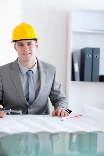 Close up of smiling architect working on a plan — Stock Photo, Image