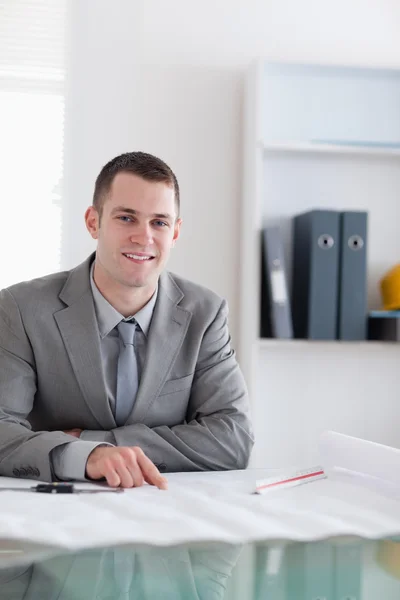 Close up of smiling architect sitting behind a table — Stock Photo, Image