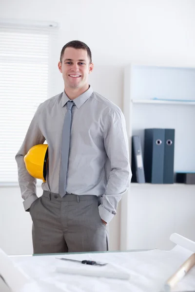 Architect standing and carrying a helm — Stock Photo, Image