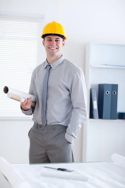 Architect standing and carrying plans — Stock Photo, Image