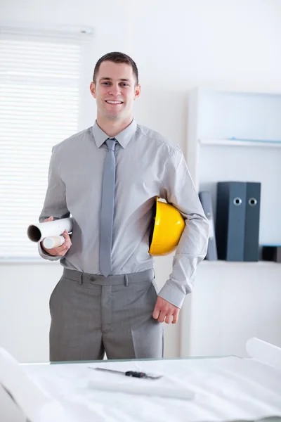 Architect carrying plans and helm — Stock Photo, Image