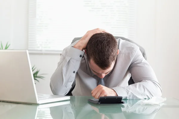 Businessman unhappy with his calculations — Stock Photo, Image