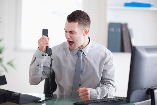 Businessman shouting at the phone — Stock Photo, Image