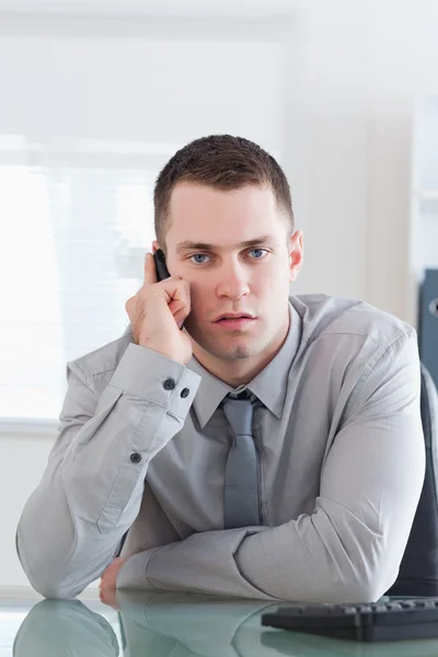 Businessman getting a serious call on his cellphone — Stock Photo, Image