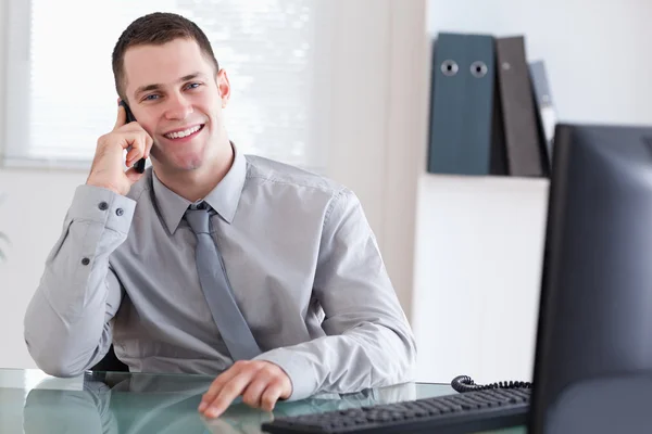 Businessman getting pleasant news on the cellphone — Stock Photo, Image