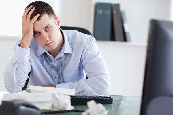 Close up of frustrated businessman doing his accounting — Stock Photo, Image