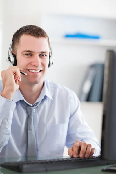 Nahaufnahme eines lächelnden Callcenter-Agenten, der mit Kunden spricht — Stockfoto