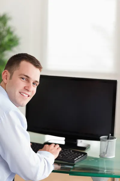 Sombreando um homem de negócios trabalhando em seu computador — Fotografia de Stock