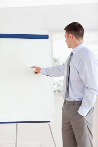 Businessman pointing at the middle of a flip chart — Stock Photo, Image