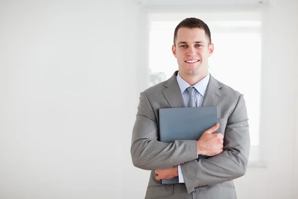 Businessman with folder in his arms — Stock Photo, Image