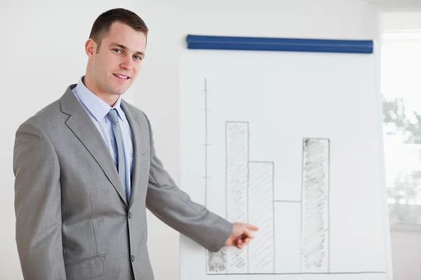 Businessman pointing at diagram — Stock Photo, Image