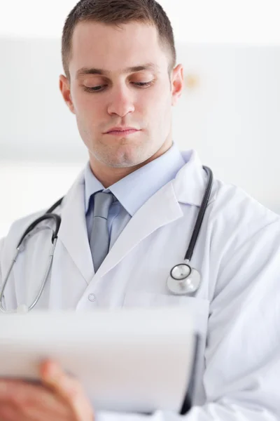 Close up of doctor checking notes — Stock Photo, Image